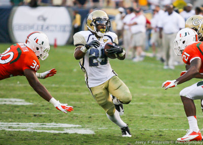 Yellow Jackets A-back Robert Godhigh avoids Miami tacklers in the secondary