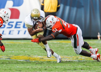 Yellow Jackets QB Washington is tackled in the open field by Hurricanes DL Shayon Green