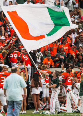 Hurricanes Cheerleader waives the flag in front of the Miami faithful
