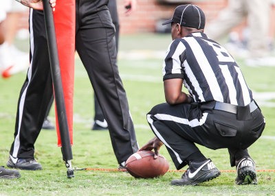 Officials measure for a first down after the Tech fourth and one play in overtimeshort