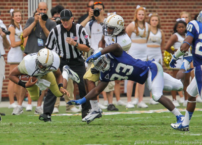 Georgia Tech QB Washington is upended along the sidelines by Middle Tennessee State LB Roderick Blunt 