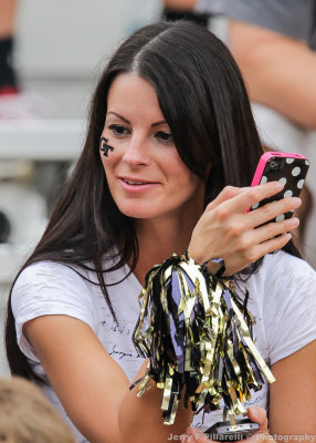 Tech Fan checks her messages during a break in the action