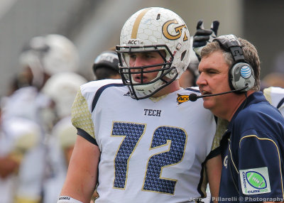 Georgia Tech Head Coach Paul Johnson sends in a play with OL Morgan Bailey