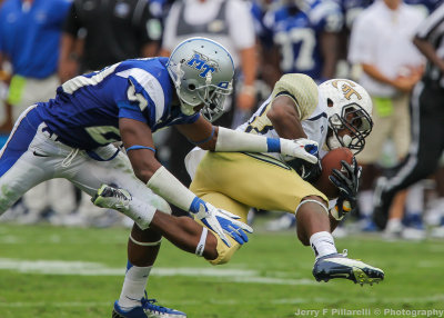 Yellow Jackets A-back Zenon is brought down by a Blue Raiders defender