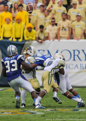 GT A-back Robert Godhigh looks for the loose ball after it was knocked out of his hands…
