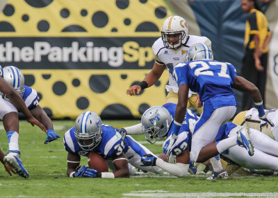  Middle Tennessee State LB Craig Allen jumps on the fumble by Tech A-back Godhigh