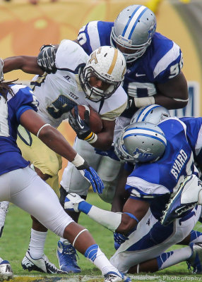 Jackets A-back Zenon is tackled by a host of Blue Raider defenders