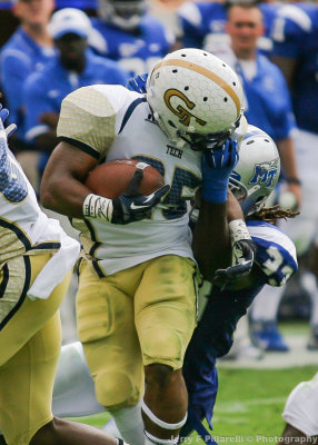 Tech A-back Godhigh has his facemask grabbed by Middle Tennessee State LB Blunt