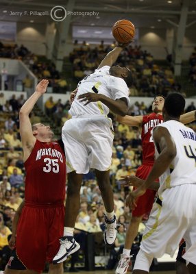 Jackets F Gani Lawal stretches for a rebound over Terrapins F Dave Neal