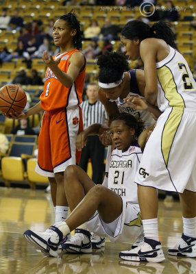 Tigers G Christy Brown questions a foul call against her as Tech teammates help F Janie Mitchell to her feet