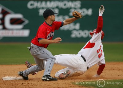 Wildcats SS Robert Abel gets the throw as Bulldogs 1B Poythress slides in safely