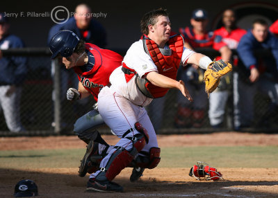 …and collides with the Bulldogs catcher…
