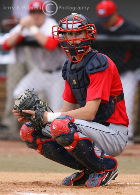 Arizona C Childs peers into the dugout for a sign