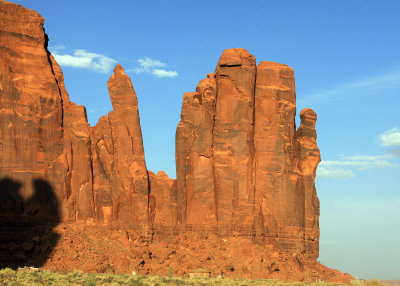 Sandstone formation towers over a Navajo home