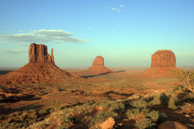 The setting sun begins to form long shadows in Monument Valley