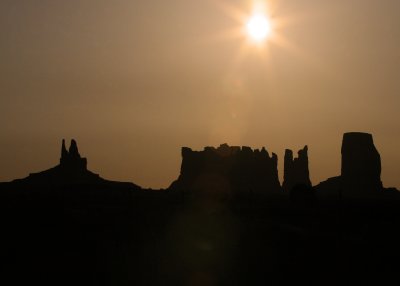 The sun setting on The King on his Throne, Stagecoach, Bear and Rabbit and Castle Butte