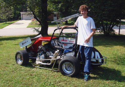 Proud owner of Number 24; my neighbor's boy, James. I still can't believe that a boy this tall can squeeze into a cage, that small and rip around a track at fifty miles an hour.