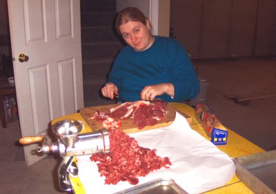 Shown above is my wife, Salena. I would cut up the meat and she would take the fat off the pieces I handed her. We then took turns with the grind. The front half of the animal is pretty much all grind, for sausage, hamburger and stew meats. The rear half of the animal and the top portion of the back is where you get your steaks from.