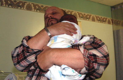 Daddy holds his boy, Isaac. He waited a very long time for this little boy. It's a wonder he puts him down at all.