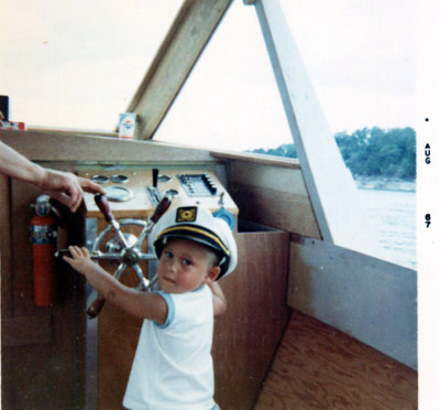 I remember this trip. My father paid this fool to take us around the lake in his boat. Look at these two pictures & you tell me if this boat looks sea worthy to you? It's made of plyboard for crying out loud.