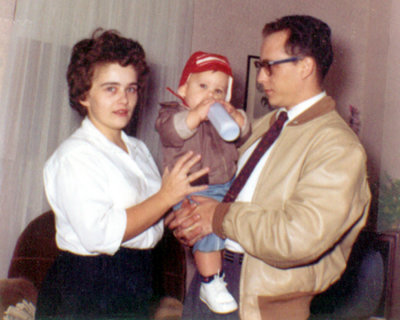 This was me with my parents at a year old. My daughter Hazelmarie has very similar features & mannerisms. Genetics are fascinating.