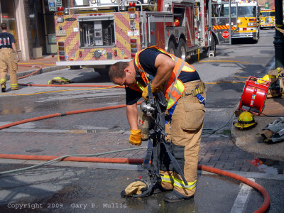 A firefighter checks an air pack.jpg