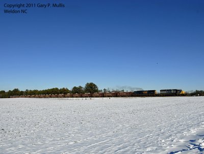 An SD40-2 leads a loaded ballast train south.jpg