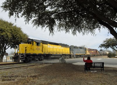 A young lady waves to the crew on a CLNA train.jpg