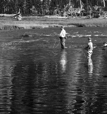 Men fishing in river