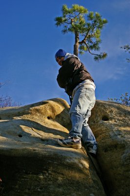 Edgar getting up the entry crack with help of a fixed rope.