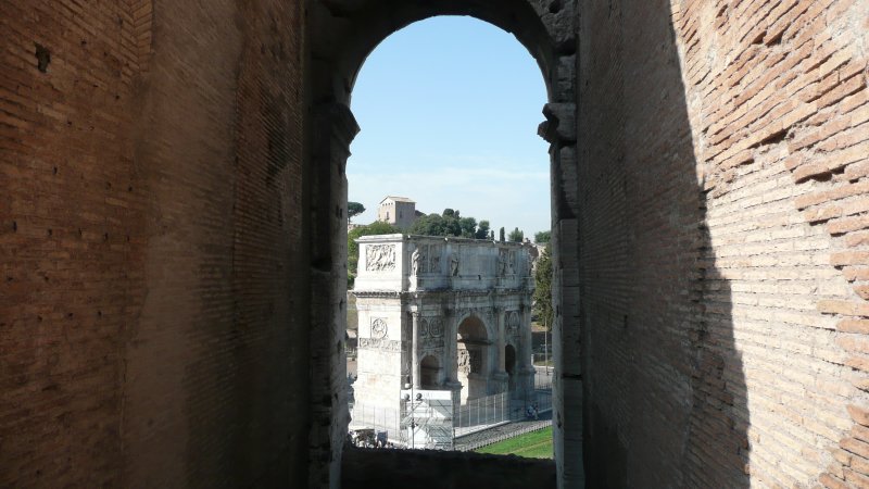 A view of Constantines Arch through the wall of the Colosseum.