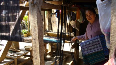 This woman sells the cloth she has woven on her own loom.