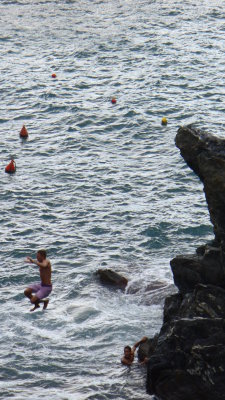 Young men were leaping off the rocks into the water.