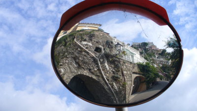 The roads are narrow with many blind curves.  Drivers rely on parabolic mirrors.