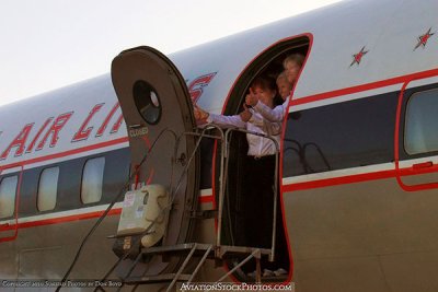 2010 - Stewardesses waving goodbye onboard the restored Eastern Air Lines DC-7B N836D flight to Oshkosh stock photo #1259