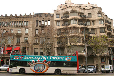 Barcelona tour bus stopping outside Gaudi's Casa Mila
