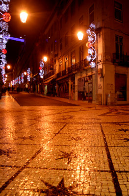 Wet pavement and holiday lights