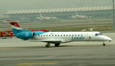 Luxair ERJ taxi away from its parking stand, MAD, Jan 2009
