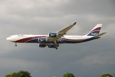 Arik's A340-500 approaching LHR 27L  while the thunder clouds gather