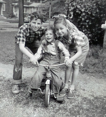 Third child Howard is born in Kew Gardens, NYC in 1950. Some years later, Gene and Carol show him how to ride a bike.