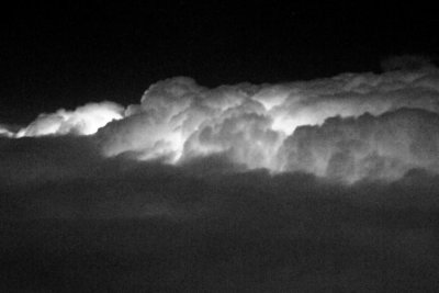 Lightning viewed from above the clouds (through a dirty airplane window)