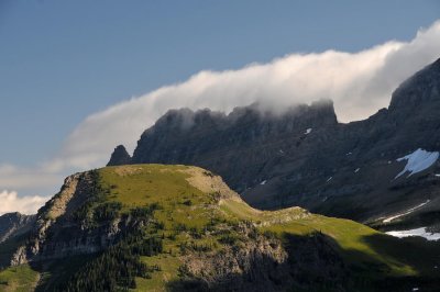 Clouds roll over the peaks near Logan Pass