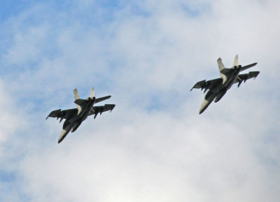 Two F-18 Hornets pass over to start the game