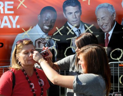 Brenda getting the OSU logo painted on while the ESPN Game Day guys look on