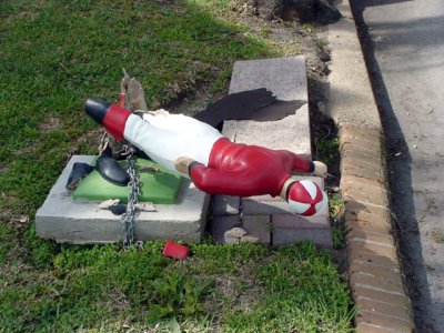 Some drunk thought this lawn jockey looked like a fun kicking target.     Butthead