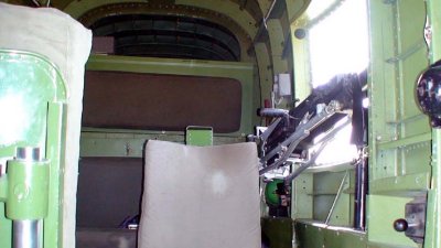 Left waist gunner. Seat was installed for passengers on demo flights