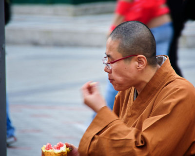 Monk eating pomegranate