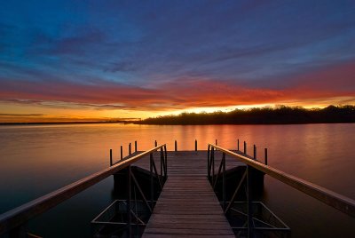 Fishing dock under firing clouds