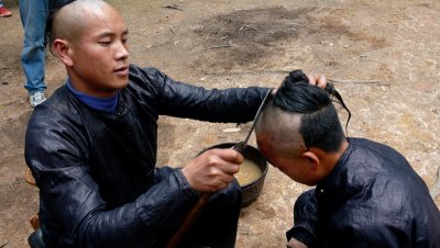 Head shaved with sickle in ceremony