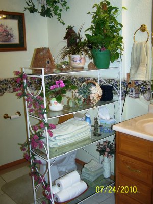 I changed out the two sets of rattan shelves for one (longer) set of wrought iron & glass shelves.